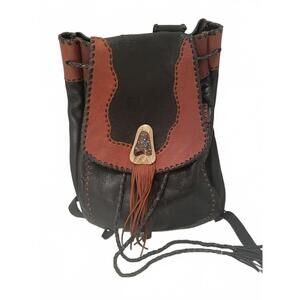 Handcrafted Leather Drawstring Backpack with Unique Ornament